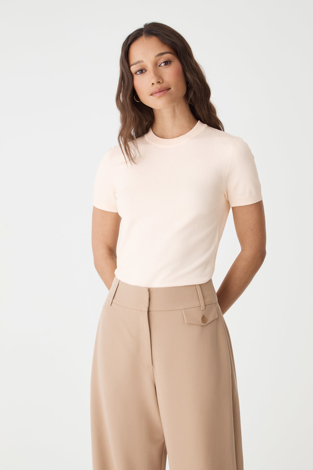 Close-up front view of the Alabaster knit top showing crew neckline and ribbed edges