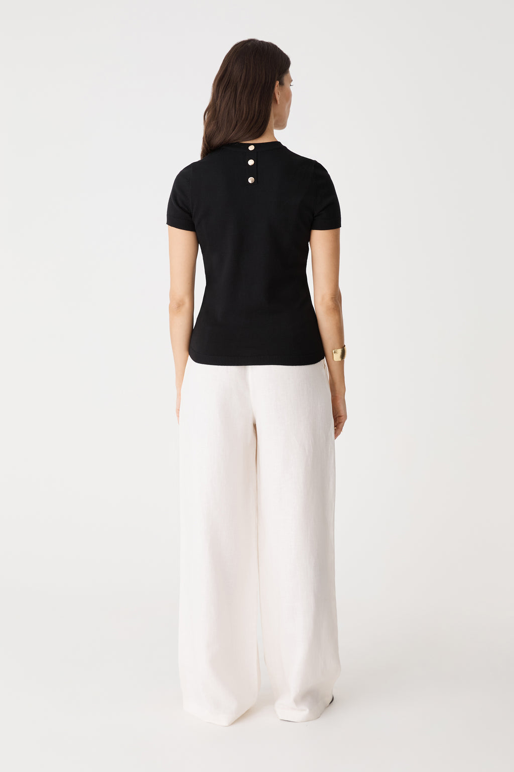 Back view showing gold-tone back neck buttons on the black Catherine Short Sleeve Knit