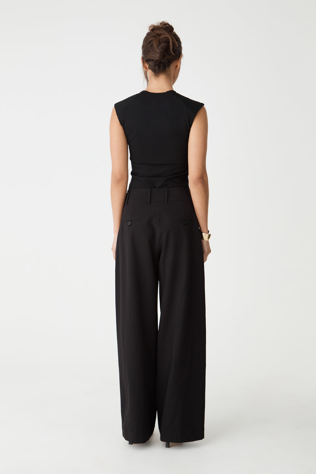 Back view of the black Soho Scoop Neck Top with black wide-leg pants