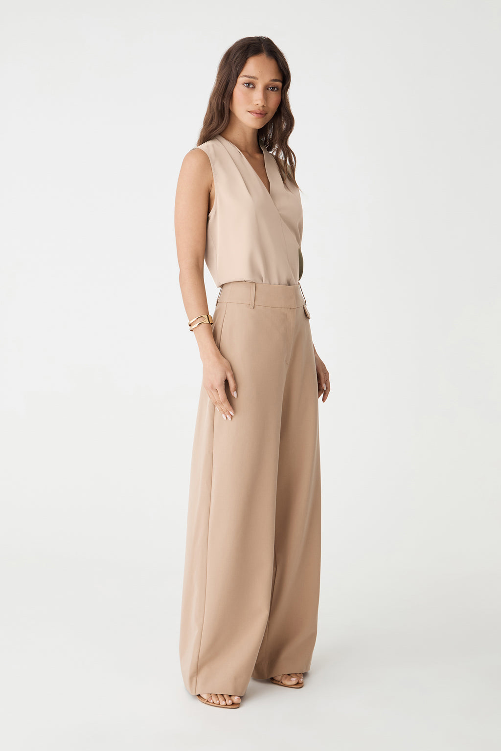 Side view of the bone top with beige wide-leg trousers