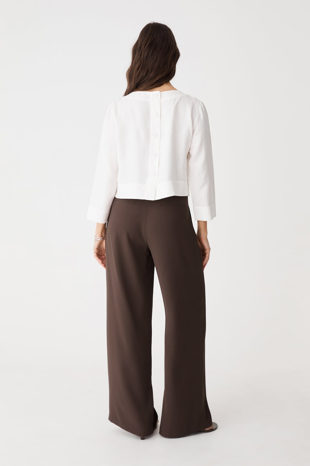 Back view showing back waist darts and double faux welt pockets