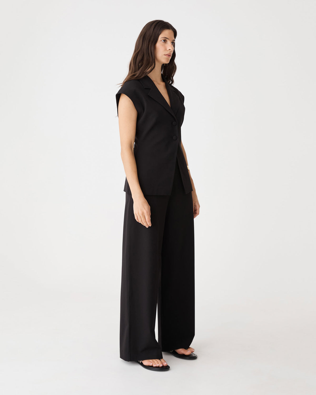 Side view of the black Milton Short Sleeve Blazer with wide leg pants
