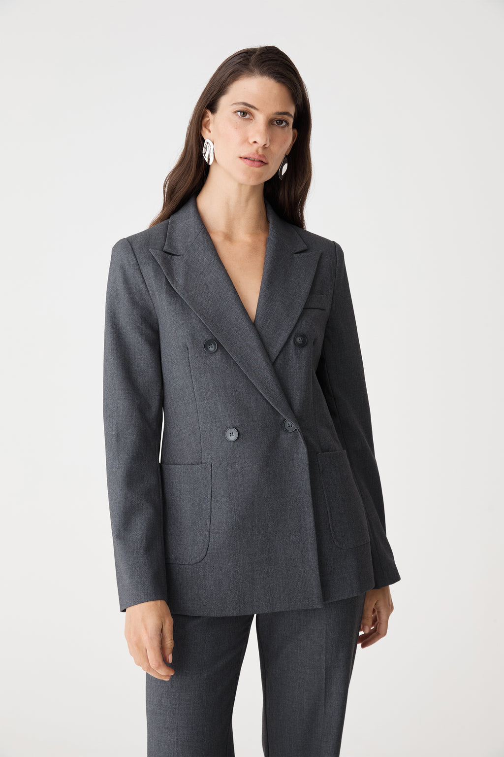 Front close-up of the dark grey blazer showing peak lapels and double-breasted button front