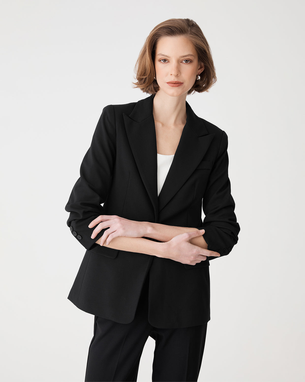 Angled view showing flap front pockets and sleeves pushed up