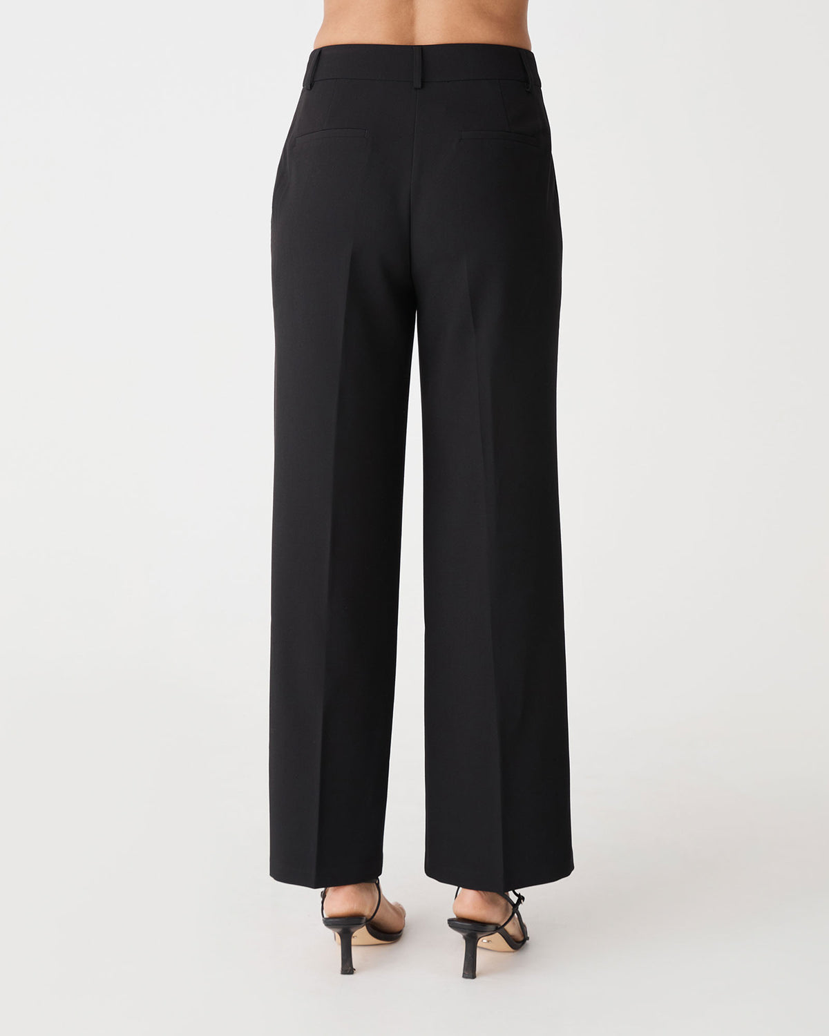 Back view of the black Nikki Tailored Pants showing faux welt back pockets