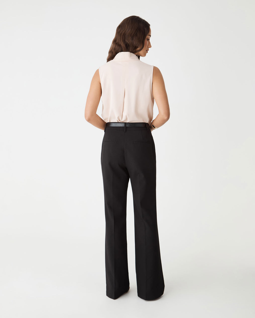 Back view of the black Nikki Flared Leg Pants with faux welt back pockets