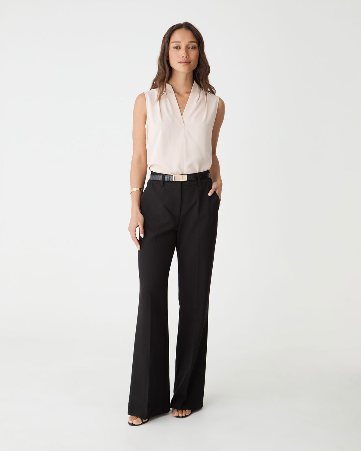 Nikki Flared Leg Pants in black, front view worn with a blush sleeveless top and belt