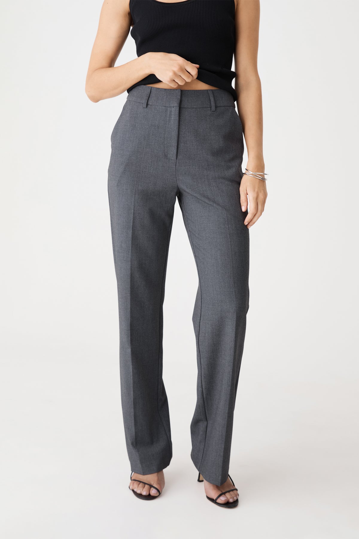 Front view of dark grey Merid Tailored Pants, straight leg, worn with black top