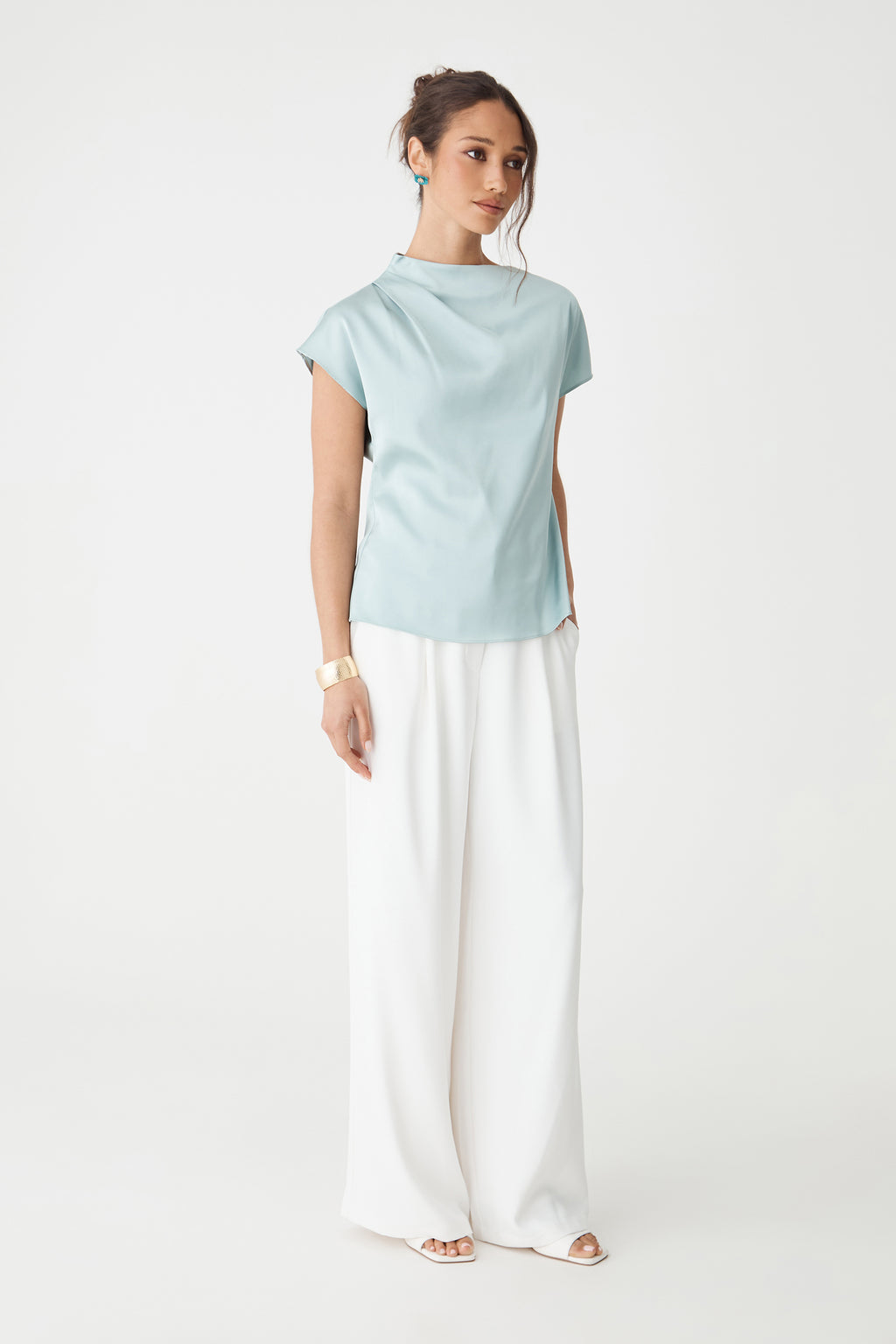 Zafina Pleated Draped Top in pale blue, front view with cap sleeves, worn with white wide-leg trousers