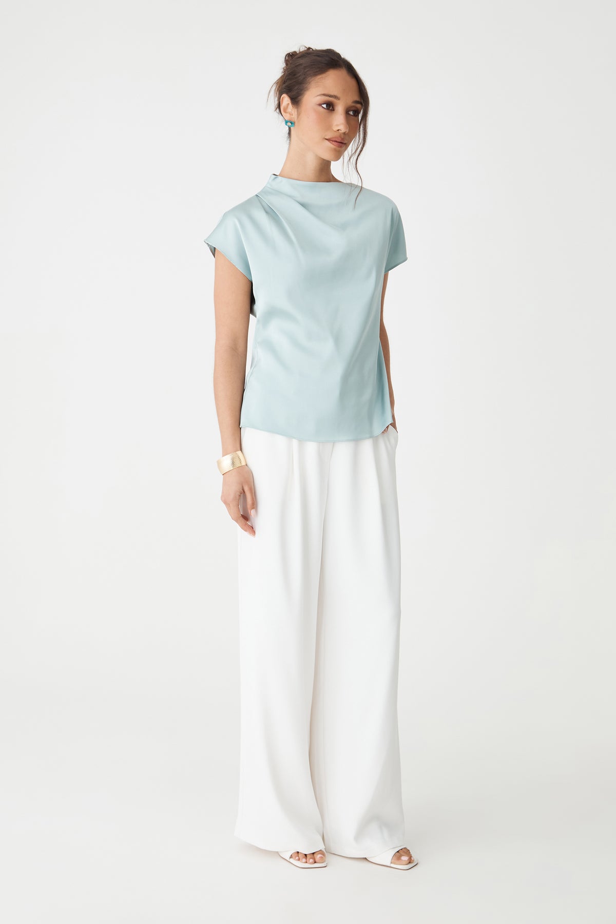 Zafina Pleated Draped Top in pale blue, front view with cap sleeves, worn with white wide-leg trousers