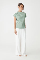 Zafina Pleated Draped Top in spearmint, side-on full-length view worn with white wide-leg trousers