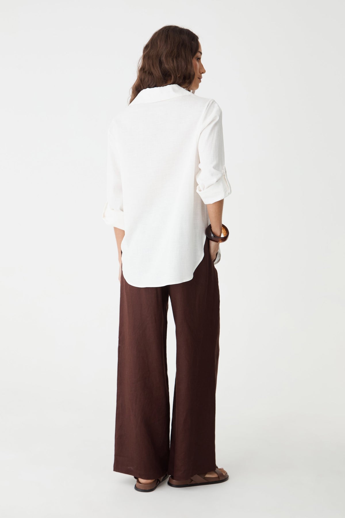 Back view of the ivory Jazie Tencel Linen Tab Shirt, worn with brown pants