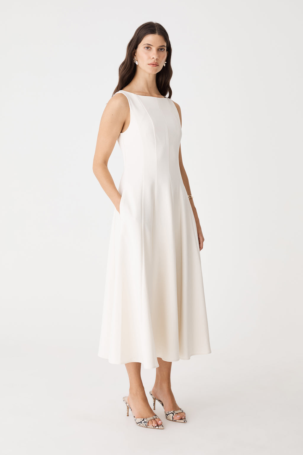 Side view of the cream Sally Panel Midi Dress with hands in side pockets