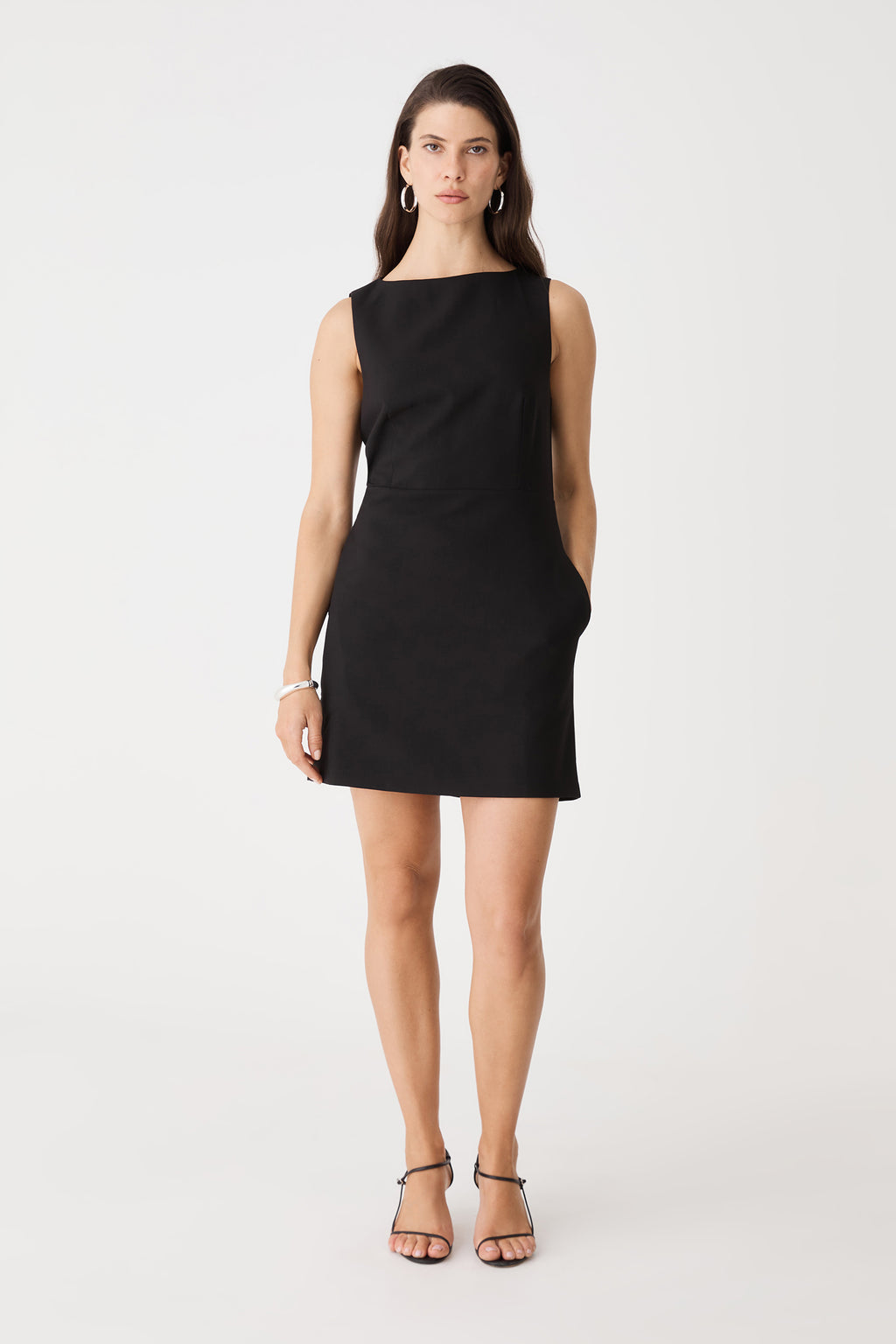 Front view of the black mini dress with hand in the in-seam side pocket