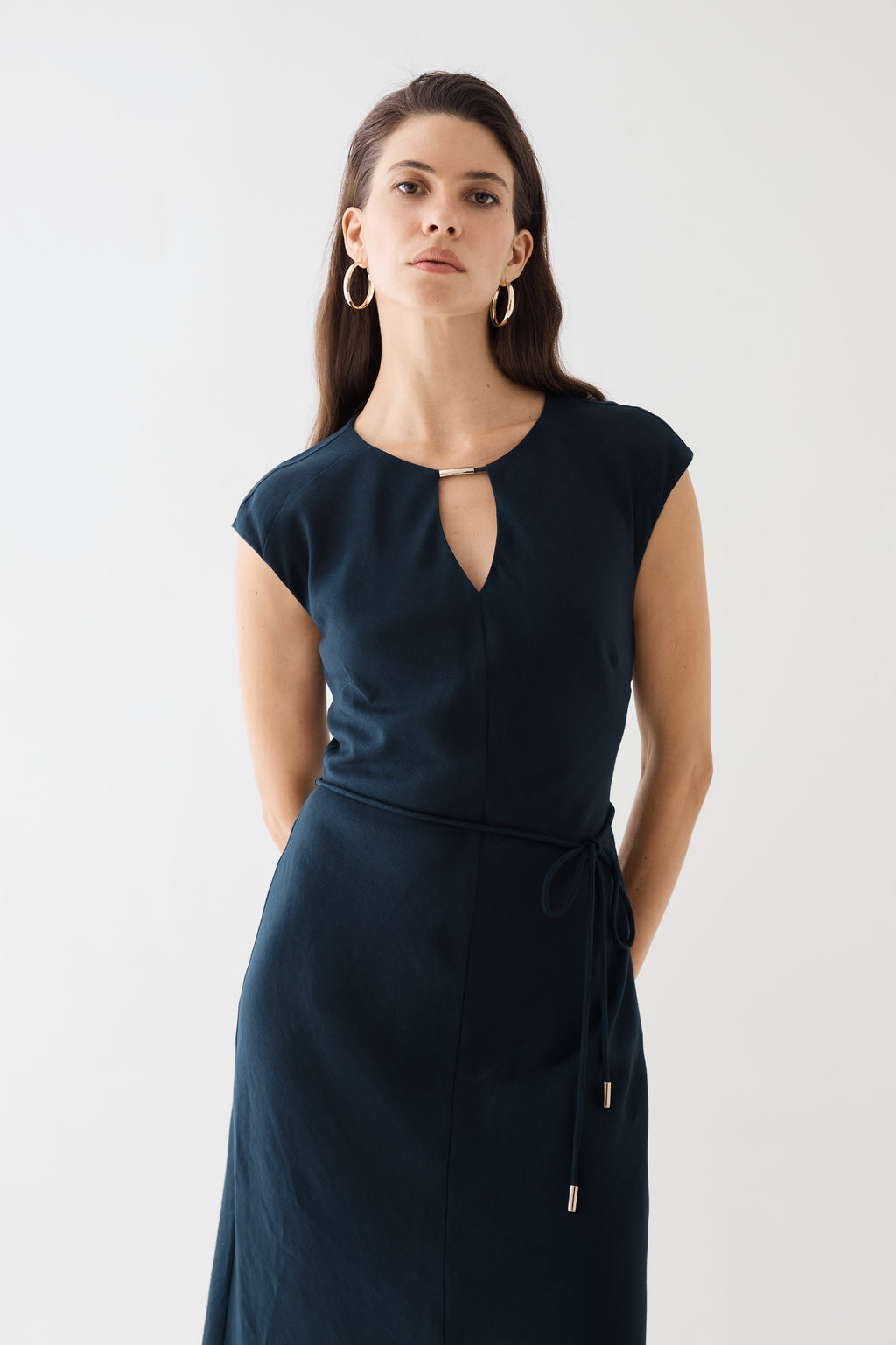 Close-up of the keyhole cut-out with gold-tone accent bar and belt ends