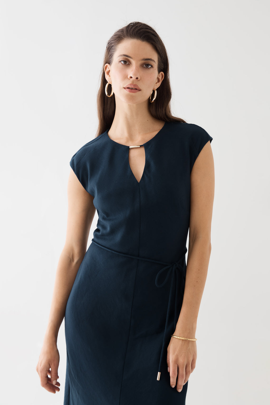 Close-up front view of the neckline and waist tie in navy