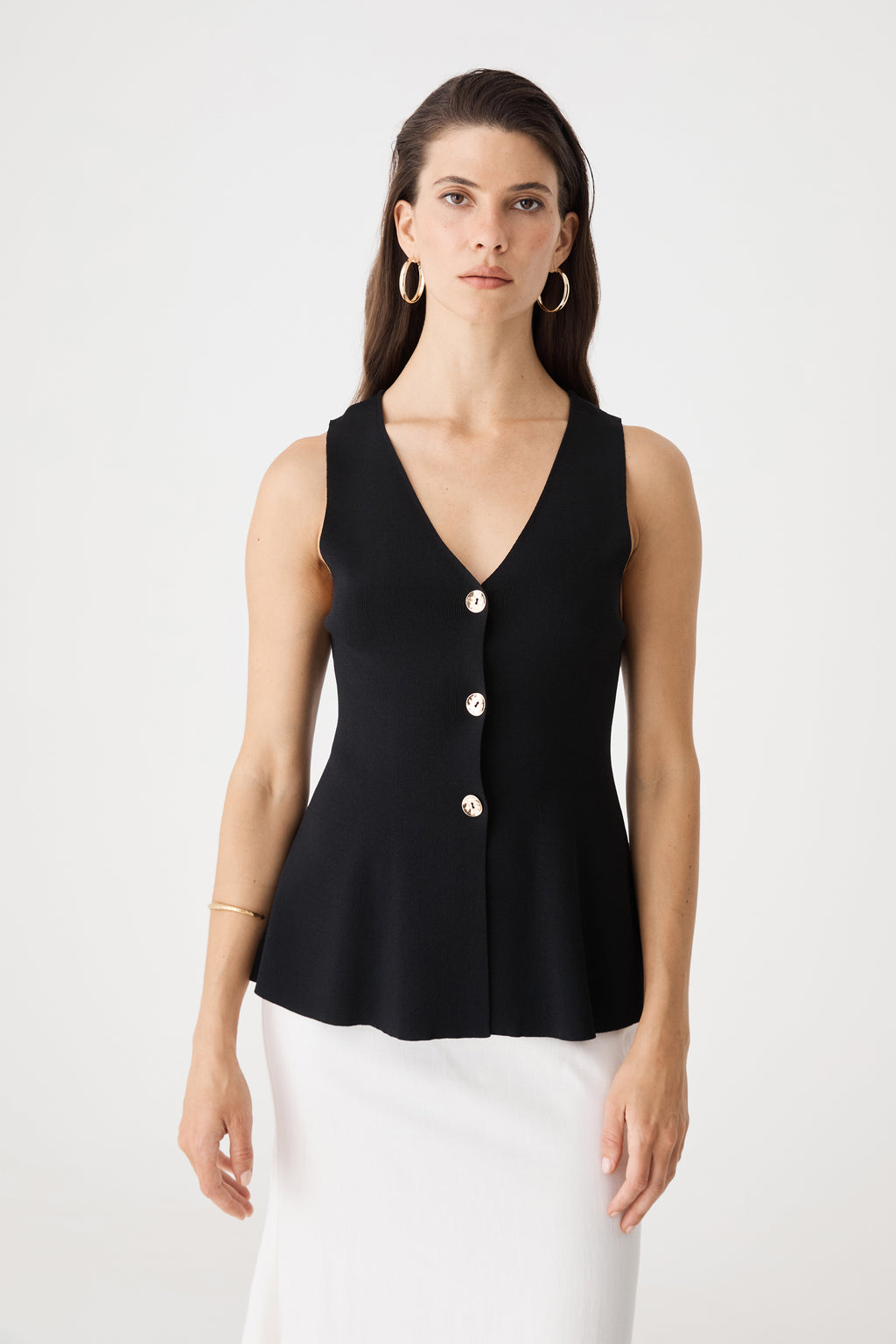 Front close-up of the black Valerie Button Peplum Knit Top showing V-neckline and gold-tone buttons