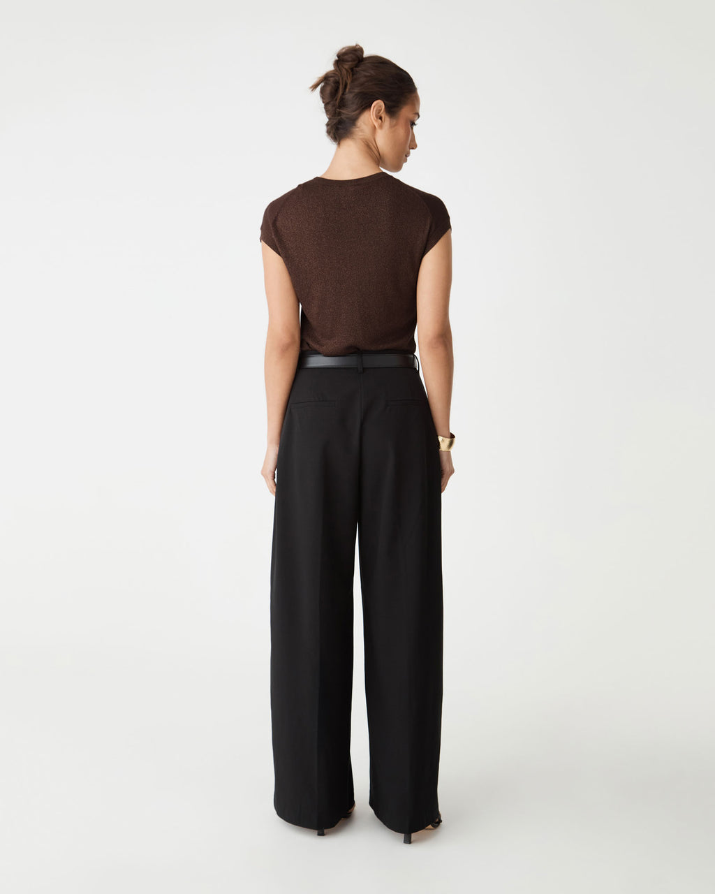 Back view of the Saskia Lurex Knit Top in Fudge with black wide-leg trousers