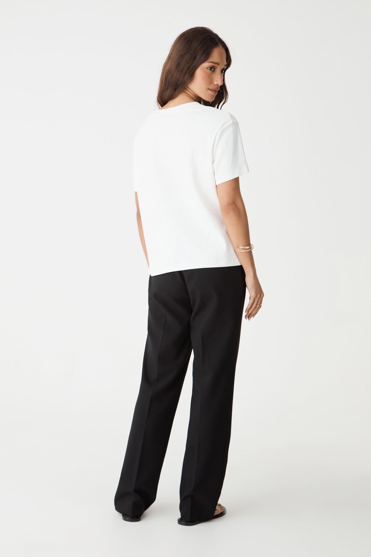 Back view of the black Nikki pants showing faux welt pockets and straight leg