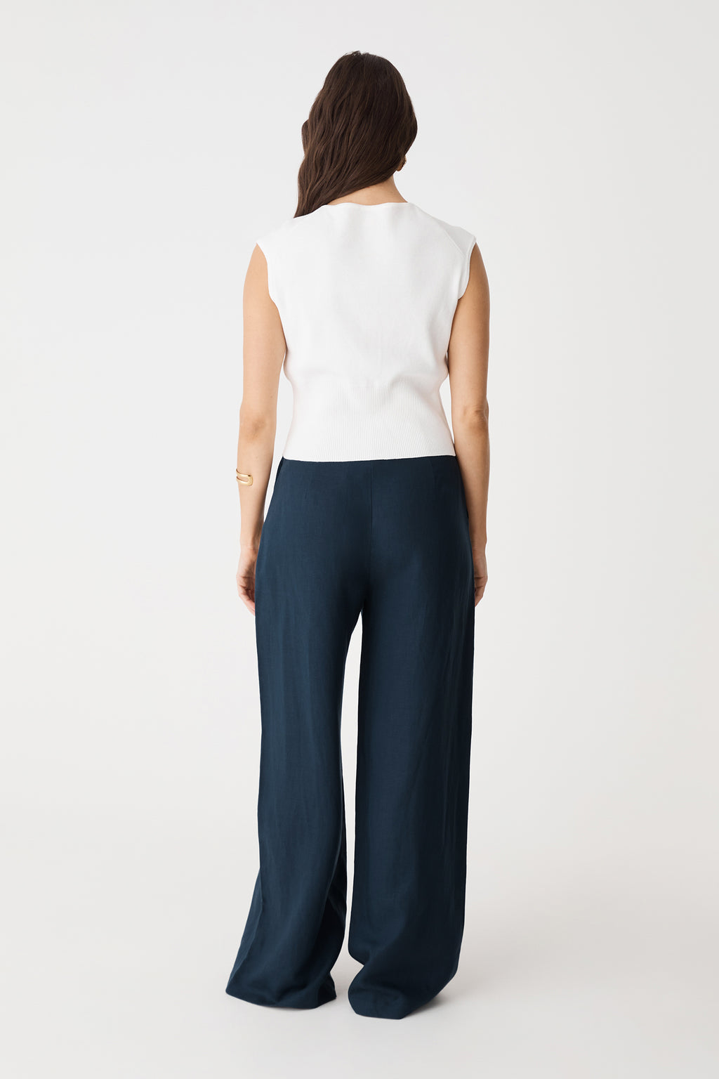Back view of the navy wide-leg pants worn with a white sleeveless top