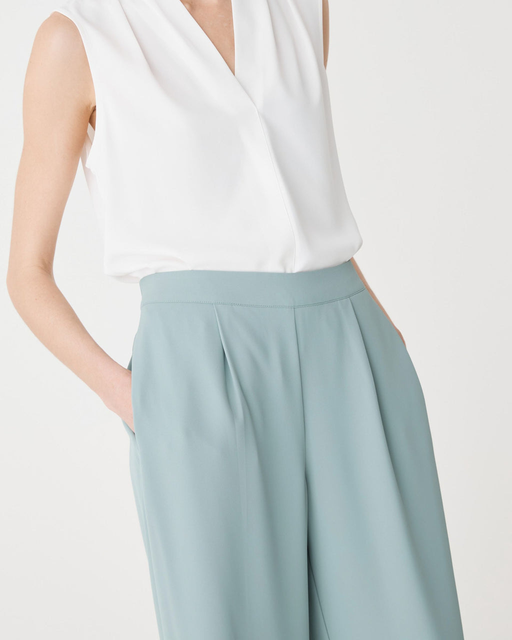 Close-up of in-seam side pocket and pleated waistband in Eucalyptus