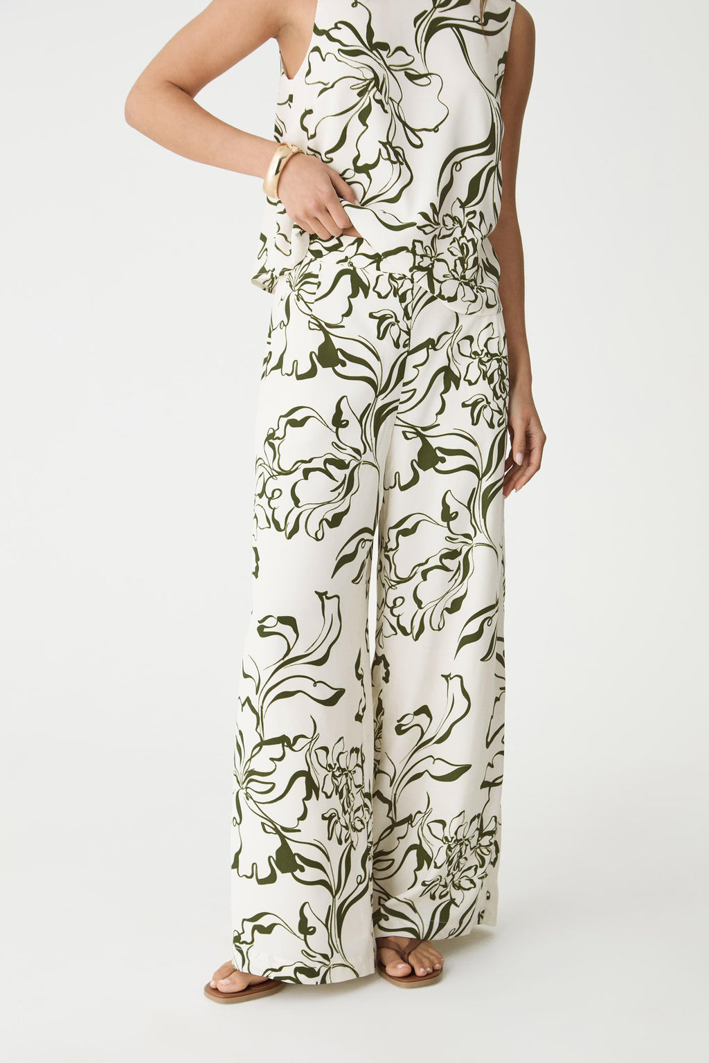 Front view of the cream and olive botanical print wide-leg pants, cropped at the waist