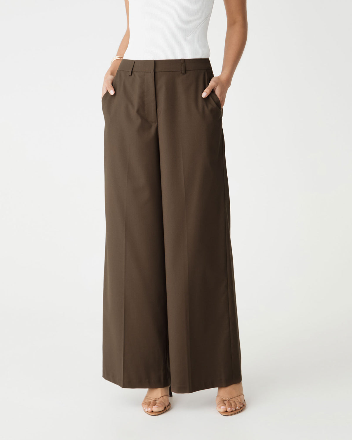 Close-up of the mid-rise waistband and side pockets on the cocoa brown wide leg pants