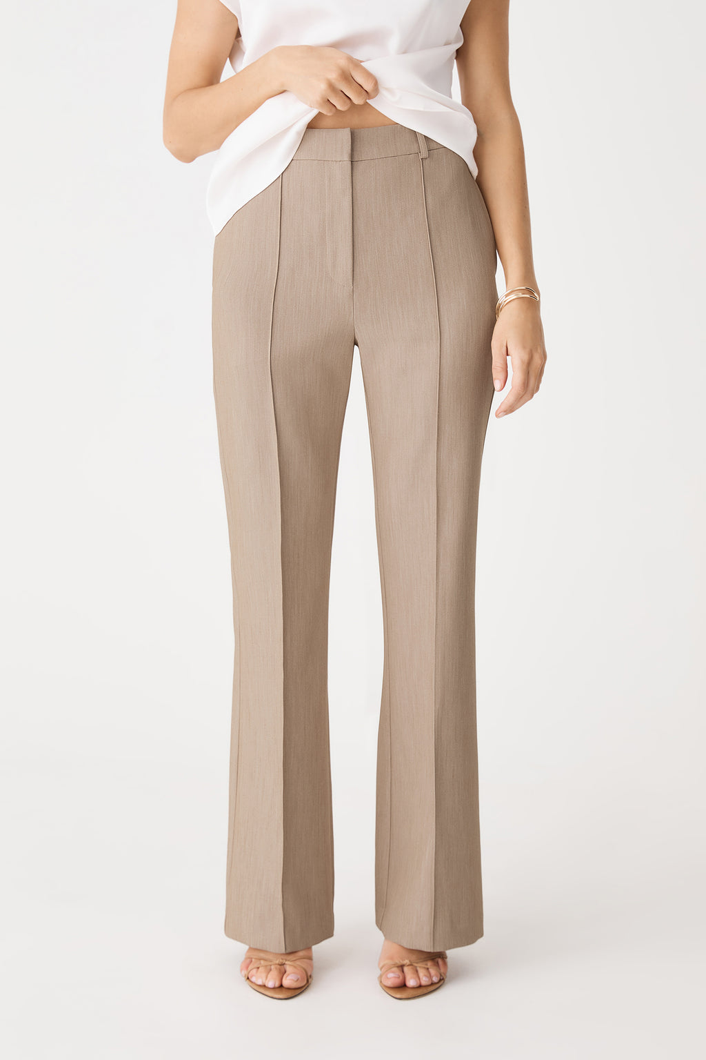 Julia Bootleg Pants in Mocha, front view showing pintuck seams and waistband, worn with white top