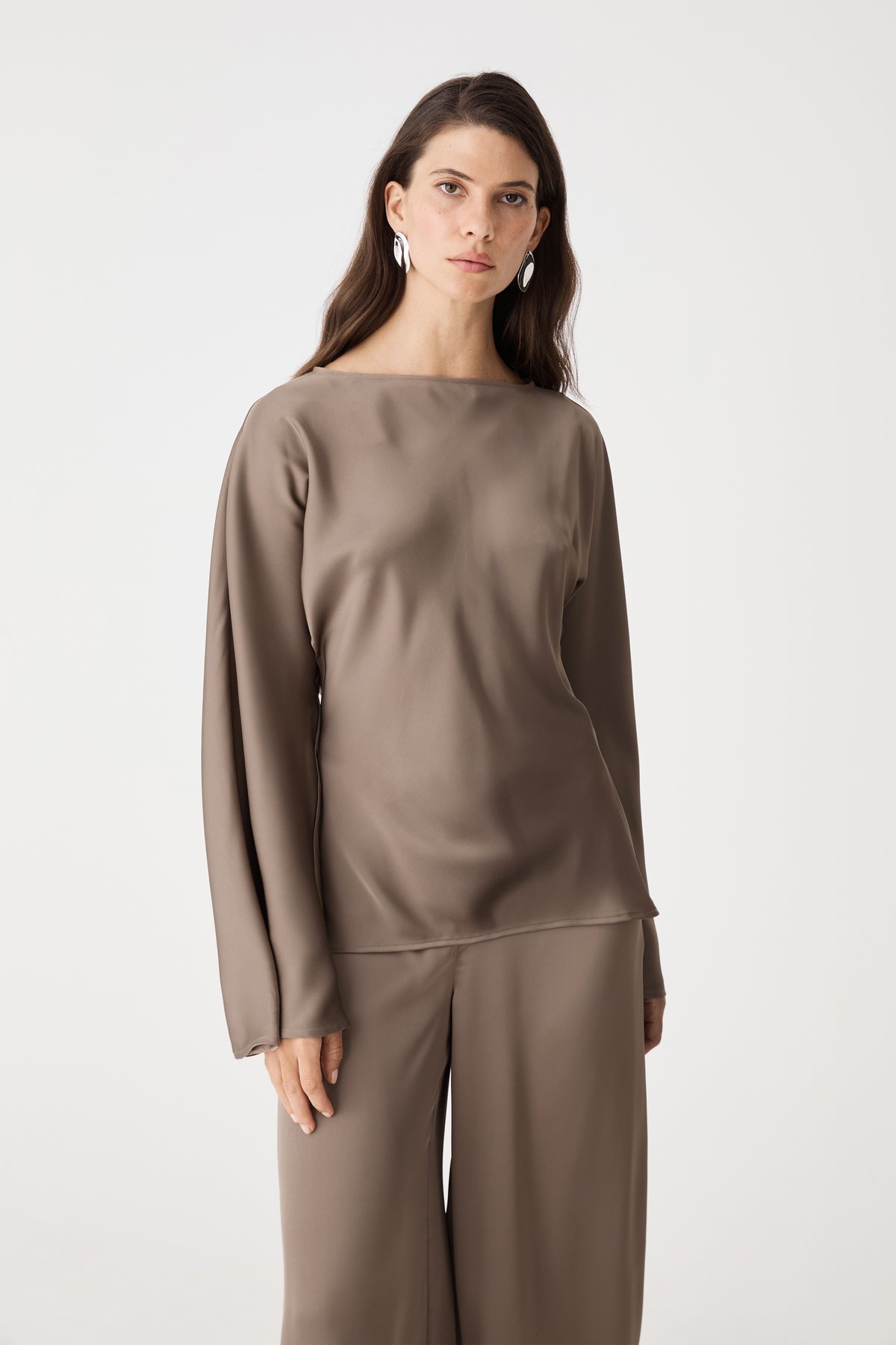 Close-up front view of the mocha satin top showing boat neckline and flared sleeves