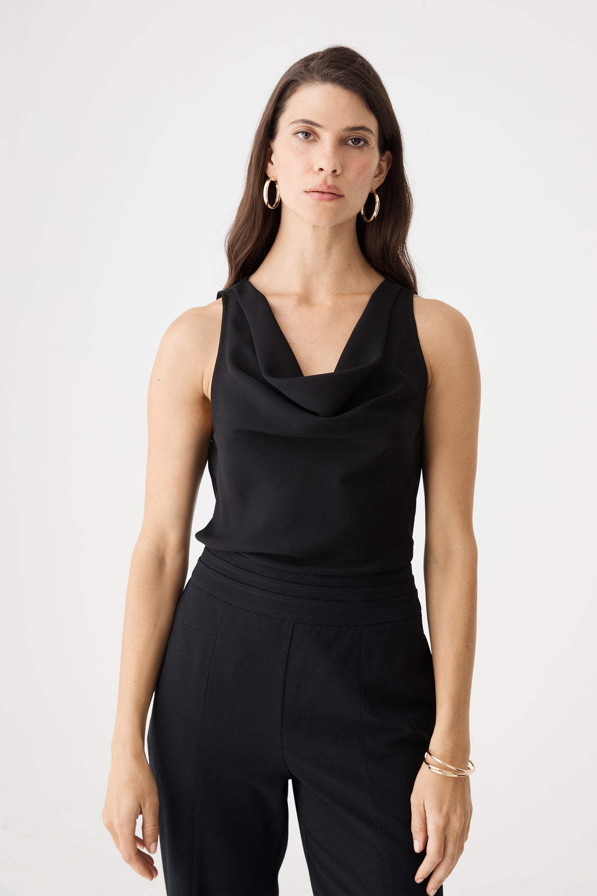 Front close-up of the black cowl neckline and sleeveless shoulders