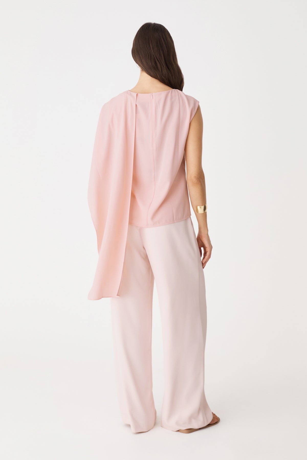 Back view of the dusty pink Cecilia Asymmetric Top with draped overlay