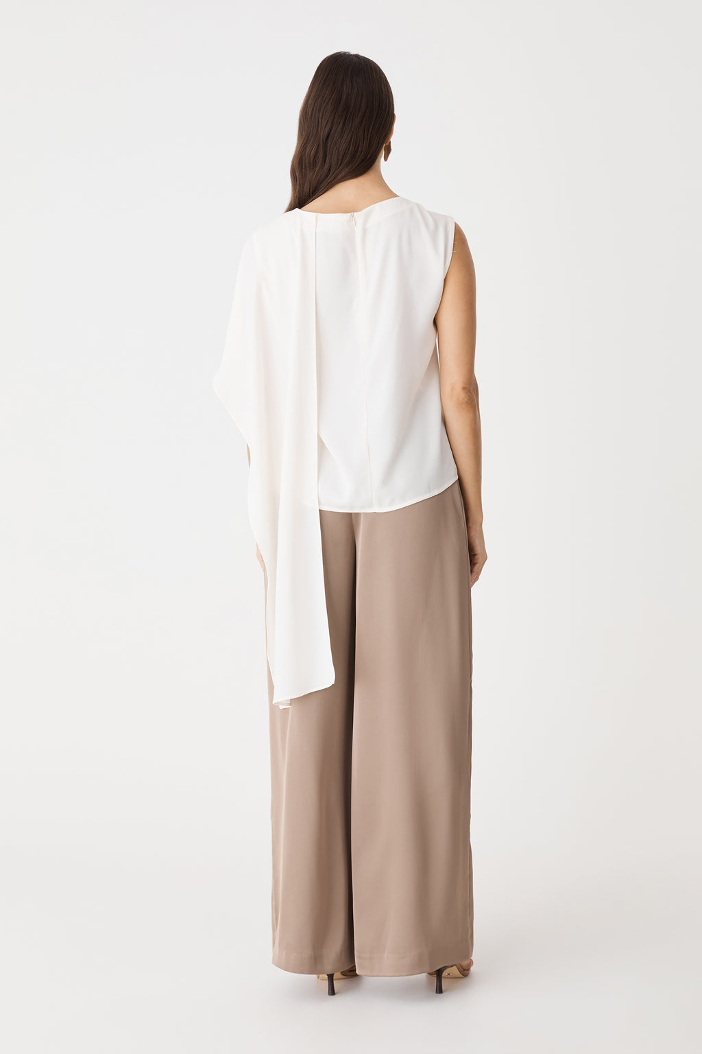 Back view of the ivory top showing invisible zipper and trailing cape drape