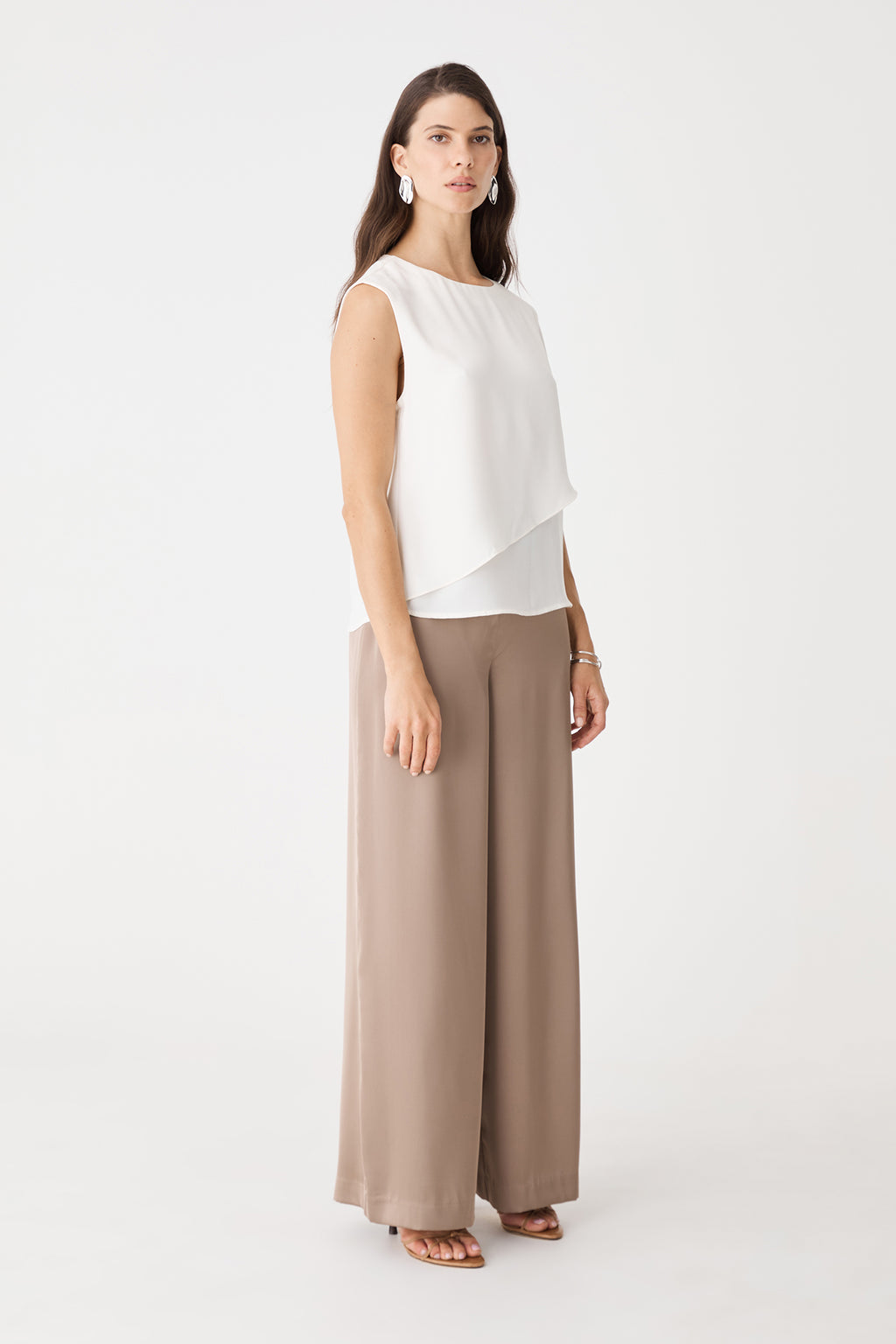 Angled view of the ivory top showing the bare shoulder and round neckline