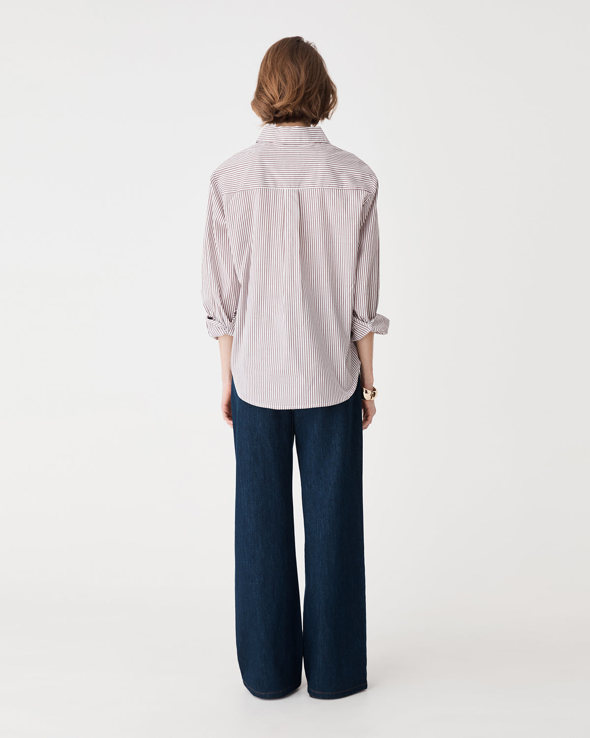 Back view of the brown stripe shirt with navy wide-leg trousers