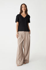 May V-Neck Cotton T-Shirt in black, front view worn untucked with beige wide-leg pants