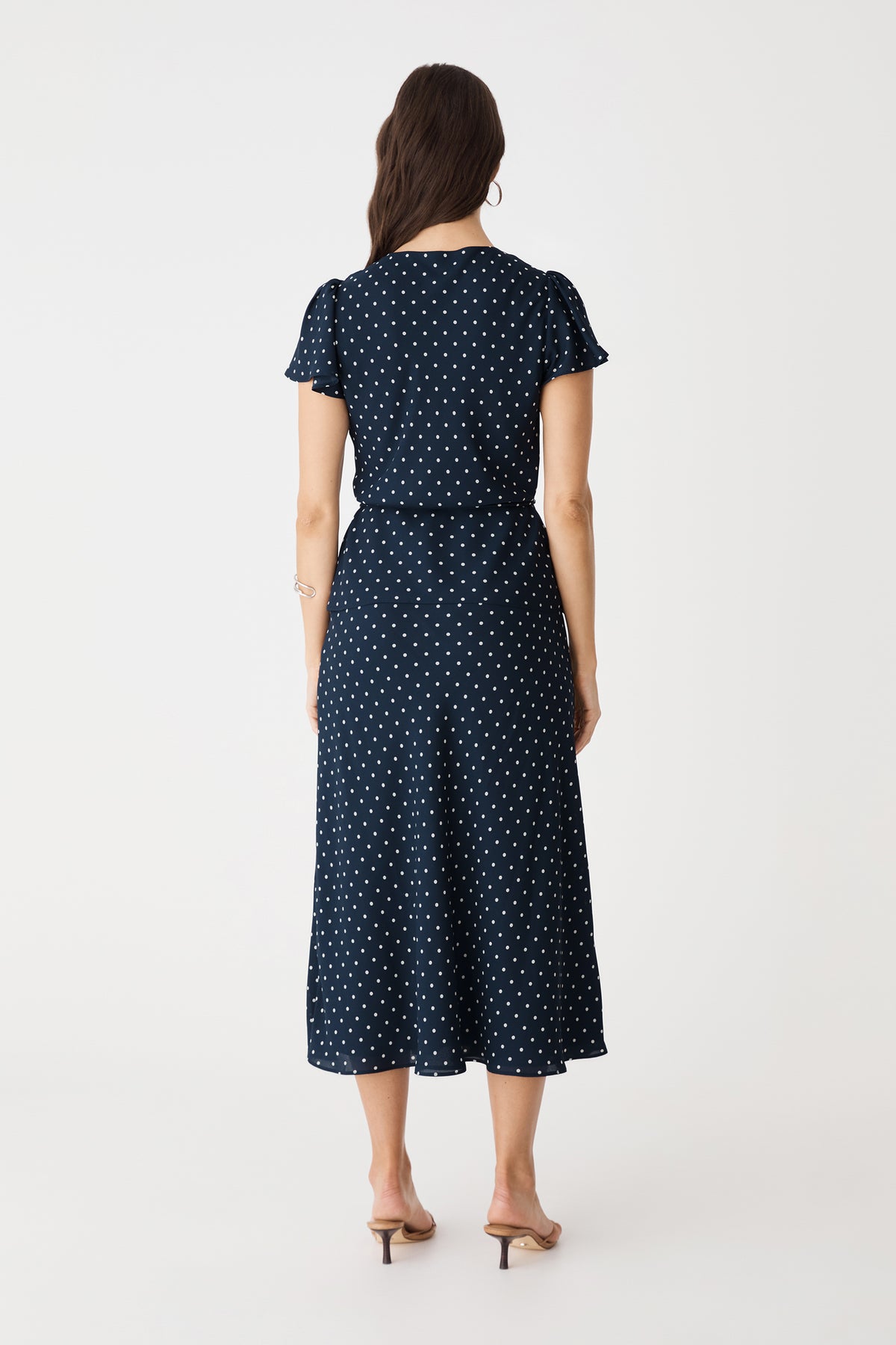 Back view of the navy spot top and matching skirt