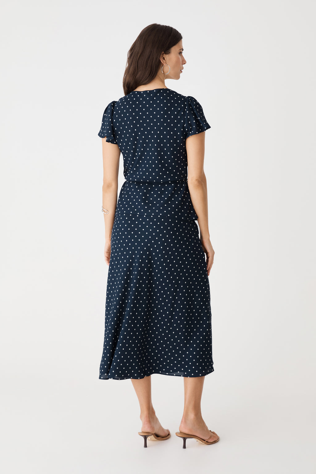 Back view of the navy spot top and matching skirt