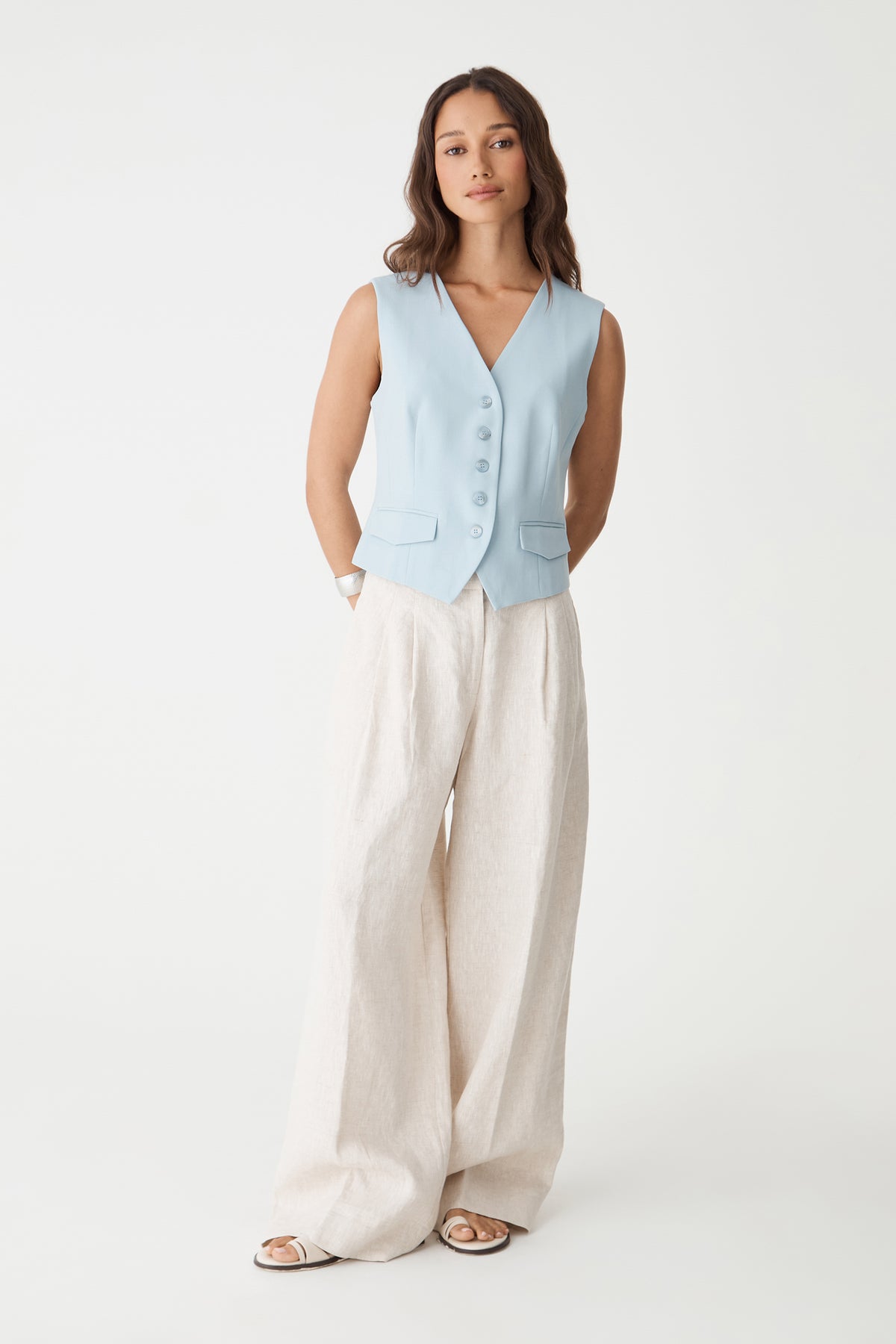 Melanie Tailored Vest in sky blue, front view worn with cream wide-leg trousers