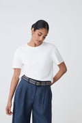 Maya Braid Belt in black and cream braid worn at the waist with a white tee and navy trousers