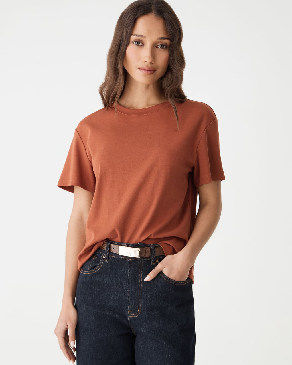 Front view of Lumi Croc Effect Belt in Tiramisu worn with rust tee and dark blue jeans