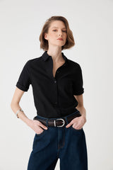 Maison Braid Leather Belt in espresso worn at the waist with a black shirt and dark denim jeans