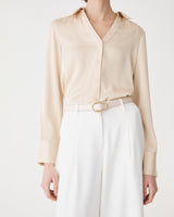 Aura Leather Belt in cream worn at the waist with a beige shirt and white wide-leg trousers, front view