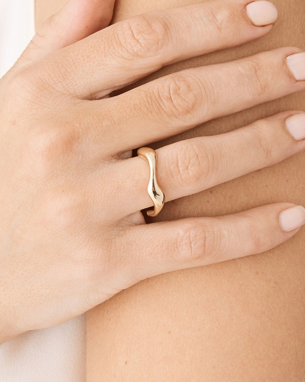 Close-up of the Julee Wave Ring in gold showing the asymmetrical wave band